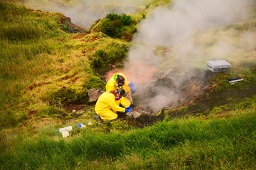 Volcanologists sample gases and water from the Geyser Bight geothermal area, Umnak Island in 2015